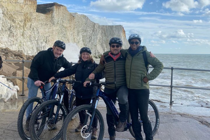 a group of people standing next to a bicycle