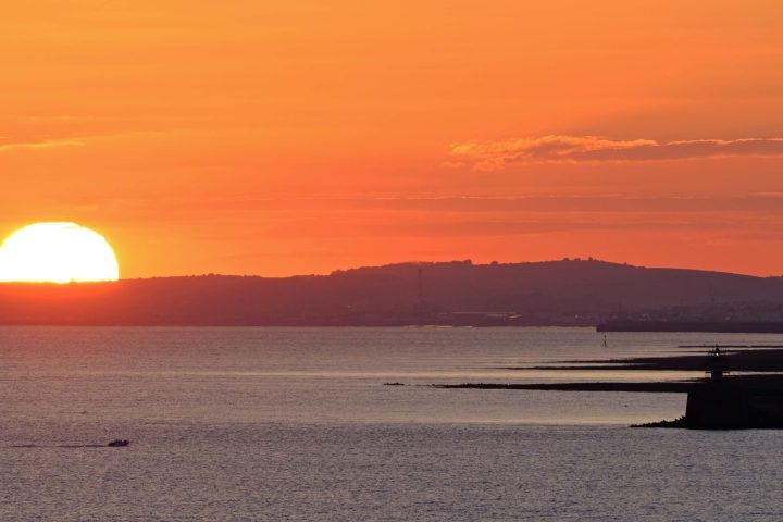 a sunset over a body of water