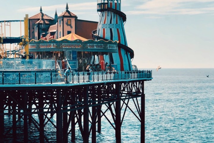 a close up of a pier next to a body of water